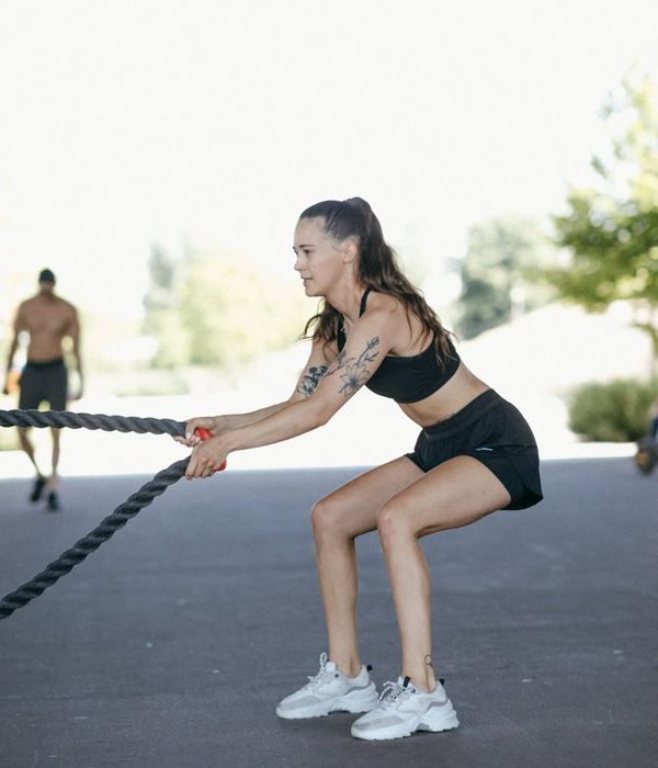 Woman performing a low-impact cardio exercise in a bright modern studio.